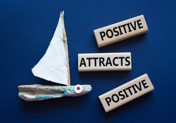 Positive attracts Positive symbol. Wooden blocks with words Positive attracts Positive. Beautiful...