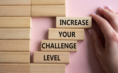 Challenge Level symbol. Concept word Increase your Challenge Level on wooden blocks. Beautiful pink...