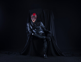portrait of a man in a monster mask on a black background
