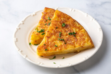 Spanish omelette with potatoes, typical spanish cuisine on gray concrete floor. Tortilla Espanola. Turkish name; Yumurtali patates
