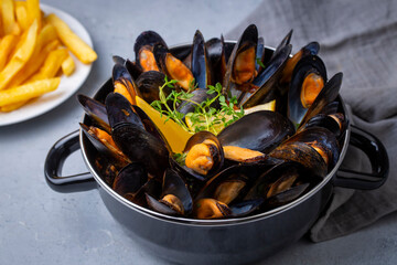 Delicious seafood mussels with parsley sauce and lemon. Delicious steamed mussels.