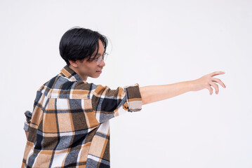 Scene of a young asian man trying to reach out with his hand. Isolated on a white backdrop.