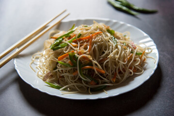 Chinese dish vegetable noodles served in a plate. Close up, selective focus.