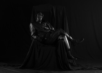 portrait of a man in a strange theatrical mask on a black background - obrazy, fototapety, plakaty