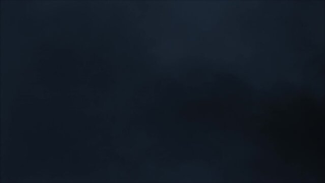 Lightning discharge and light effects in the clouds. Thunderclouds in bright flashes of lightning. Bad weather. Looped
