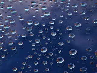water drops on glass, light refracting through water beads