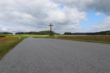 road with a large wooden cross