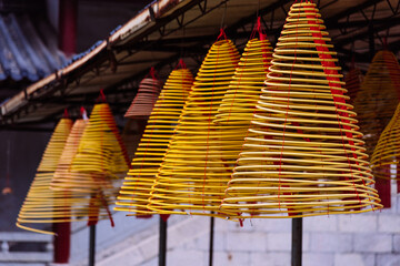 Hanging incense coils at the temple in china. Enormous rings filled with ash and fragrance are offerings to the gods and Buddha. 