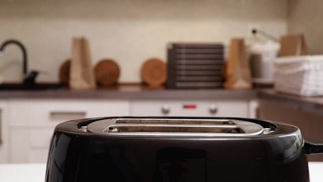 A toaster browning slices of bread, toast for breakfast