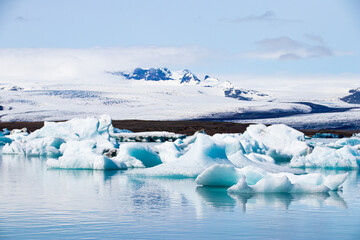 Ice floes in a glacial lake in Iceland with vulcano mountains in the background, the climate crisis in northern Europe, glacial melting, beautiful landsacpe