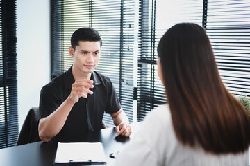 Furious male boss shouting, pointing finger at bad office worker with bad work results. Emotional...