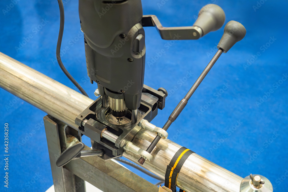 Poster drilling machine for pipes. process of creating hole in pipeline. connections of two pipes. drilling