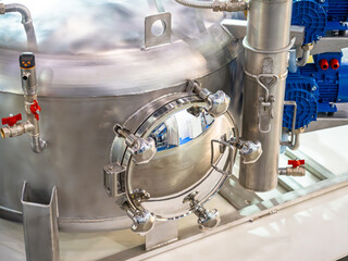 Production equipment. Chrome tank in chemical factory. Fragment of production capacity. Steel tank...