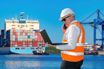 Man in seaport. Cargo harbor logistician. Port manager with laptop. Logistician man near container...