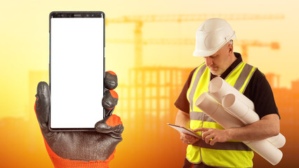 Phone in builder hand. Smartphone with blank screen. Male engineer. Guy is architect. Phone mock...