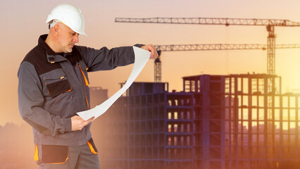 Obraz premium Man builder. Architect studies construction plan. Construction multi-storey building. Builder in protective helmet. Man engineer with architectural drawings. Construction company manager at sunset