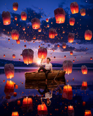 Beautiful man at the boat with sky lanterns © Alexei