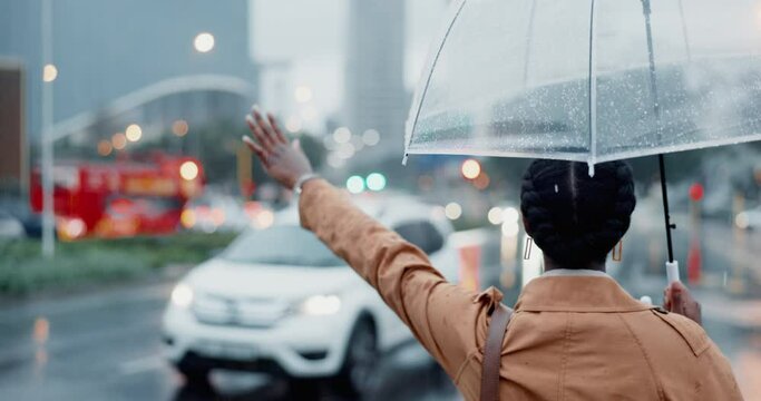 Woman, hail taxi in city and umbrella, travel and insurance in rain outdoor with back view. Commute, journey to work and professional with security in winter and wait in urban street for transport