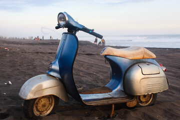 Blue Vintage scooter stands in an alley. Post process in vintage style in beach