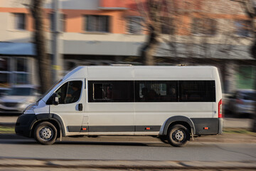 Minibus moving on city street - 642373690
