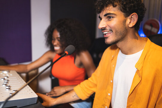 Man and black woman adjusting recorded sound