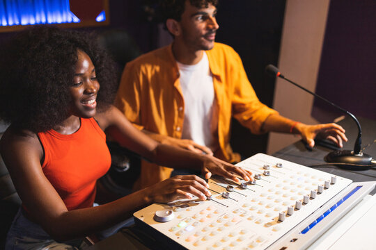 Man and black woman adjusting recorded sound