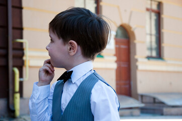 small boy in elegant tuxedo outdoor. little kid in tux suit. child in menswear. formalwear for...