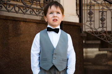 little kid in tux suit. child in menswear. formalwear for gentlemen in childhood. kid fashion for...