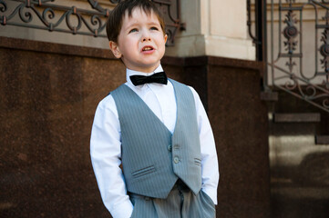 little kid in tux suit. child in menswear. formalwear for gentlemen in childhood. kid fashion for...