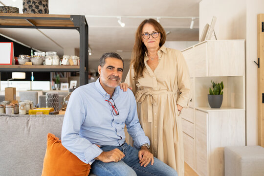 Positive couple in modern furniture shop