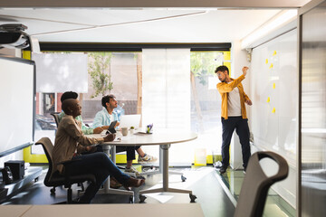 Diverse colleagues discussing project together