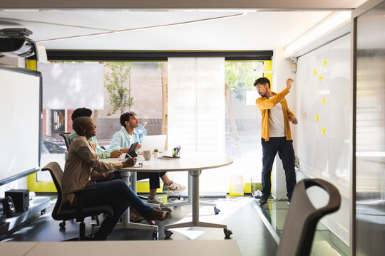 Diverse colleagues discussing project together