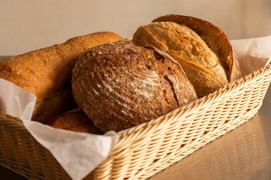 Freshly baked bread being served into wicker basket