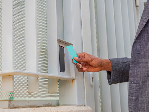 Black businessman entering door with keycard