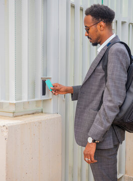 Black businessman entering door with keycard