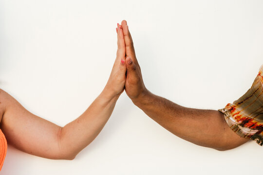 Crop diverse couple giving high five to each other