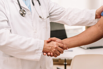 Faceless men shaking hands together