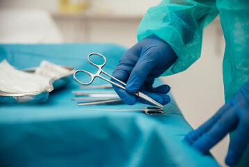 Crop doctor arranging surgical instruments on table before operation