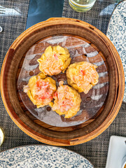 Crab and Shrimp Shumai (sui mai) Dim Sum served in bamboo steamer.