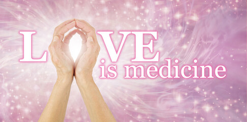 Love is Medicine and the Ultimate Healer - Female hands making the O of LOVE IS MEDICINE on a...