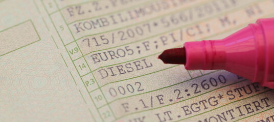 a vehicle registration document with the words (Diesel, Euro 5) and a red pen - obrazy, fototapety, plakaty