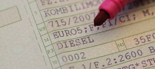 a vehicle registration document with the words (Diesel, Euro 5) and a red pen