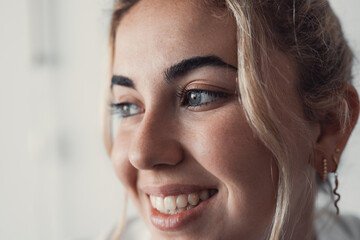 Cropped close up part of female face, happy young Caucasian woman portrait look aside, having white-toothed smile, wrinkles around eyes, staring into distance. Natural beauty, skincare treatments ad.