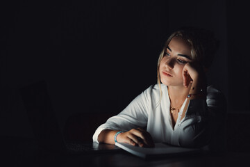 Exhausted upset young woman sit at office desk after end of workday alone massage temples trying to remember important information. Stressed tired female employee feel headache caused by work overtime