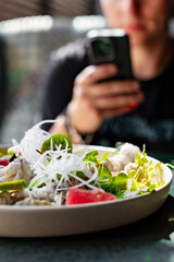 Fresh sashimi salad with salmon fish, tuna and vegetables on table