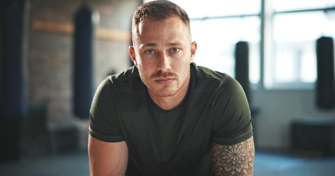 Gym, fitness and face of man athlete serious for wellness, exercise and health as a coach with workout commitment. Active, sports and portrait young bodybuilder in training centre or club for goals