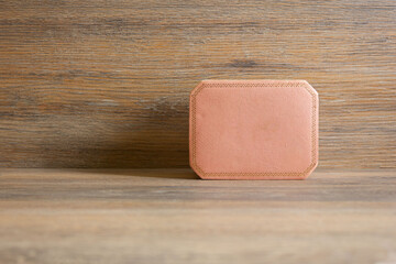 Pink jewelry box on wooden background