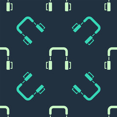 Green and beige Headphones icon isolated seamless pattern on blue background. Earphones. Concept for listening to music, service, communication and operator. Vector