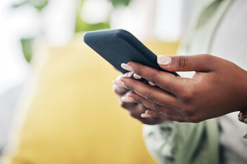 Hands of woman on sofa with phone, typing and checking social media, message or video online. Technology, internet and girl on couch with smartphone, digital app and like for viral content at home.