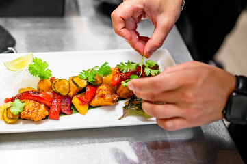 chef cooking chicken sweet and sour sauce on kitchen